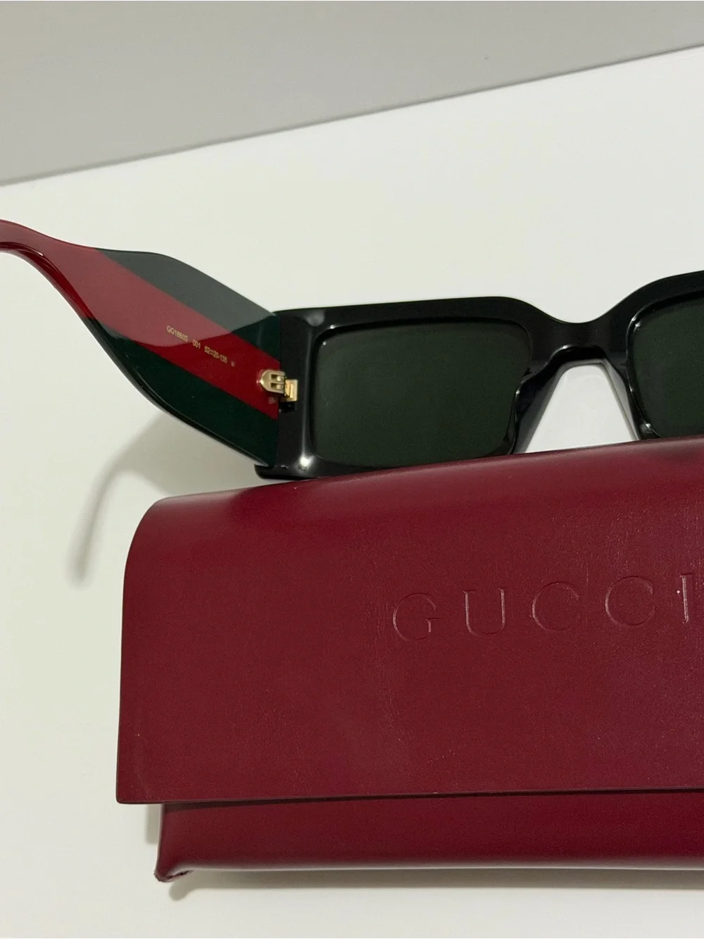 Gucci Black Frame Sunglasses with Red Temples and Gold Logo